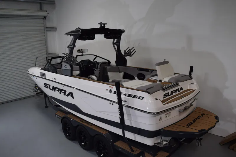 Slide: The Image of 2021 Supra SE 450 boat in a garage, showcasing sleek design and modern features. - 8