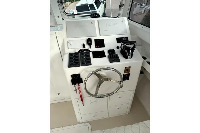 Slide: The Image of 2023 Steiger Craft 31 Fisherman helm with steering wheel and control panel. - 2