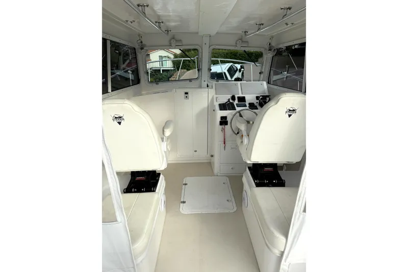 Slide: The Image of 2023 Steiger Craft 31 Fisherman boat interior with white seating and control panel. - 7
