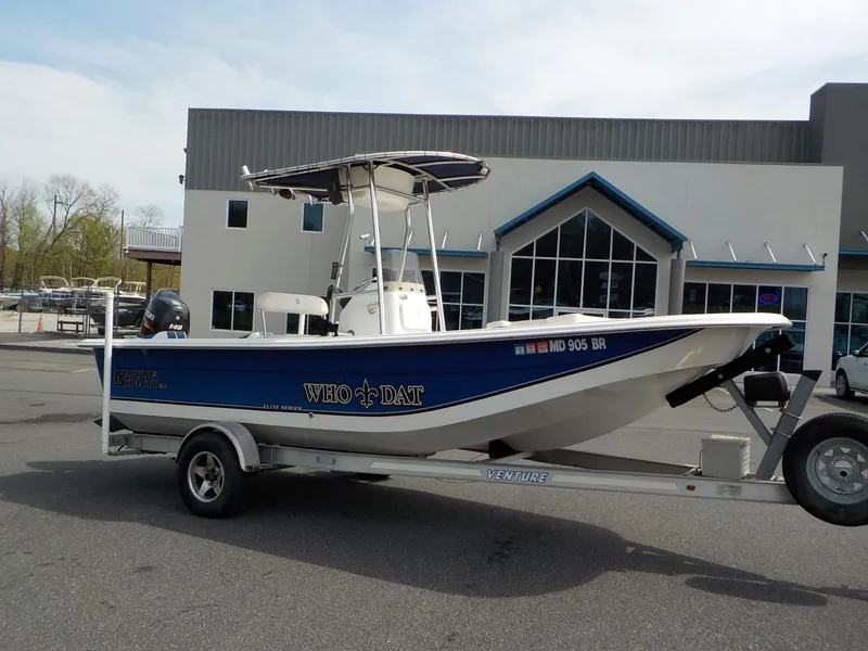 Slide: The Image of 2010 Carolina Skiff Elite Series DLV 218 on trailer in front of building. - 6