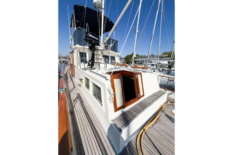 Slide: The Image of Grand Banks 36 Classic 1991 yacht with wooden deck and open hatch, docked at marina. - 10