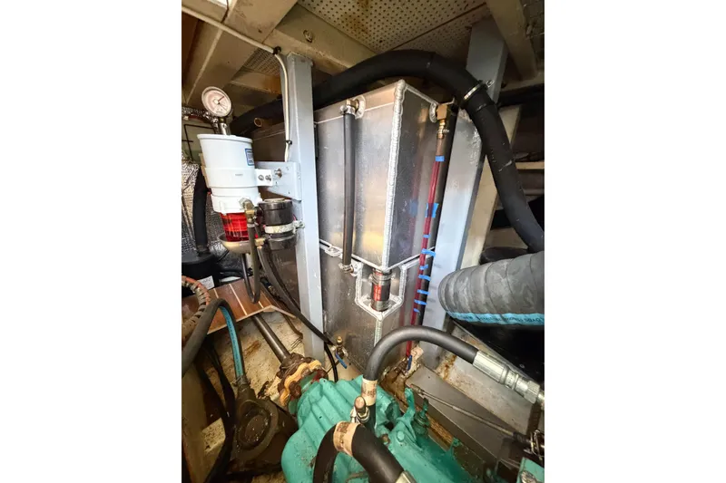 Slide: The Image of Engine room of 1991 Grand Banks 36 Classic, showcasing mechanical components and piping. - 100
