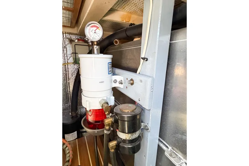 Slide: The Image of Engine room detail of a 1991 Grand Banks 36 Classic yacht, featuring a fuel filter system. - 102