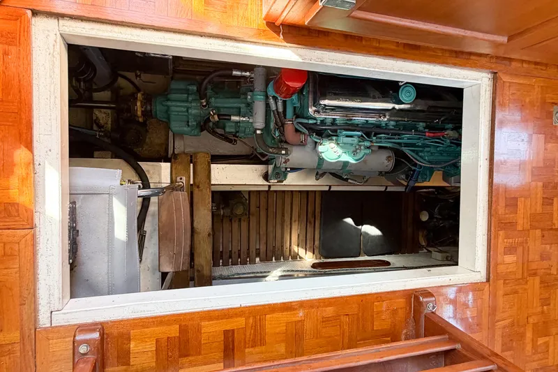 Slide: The Image of Engine room of 1991 Grand Banks 36 Classic yacht with visible machinery and wooden flooring. - 103