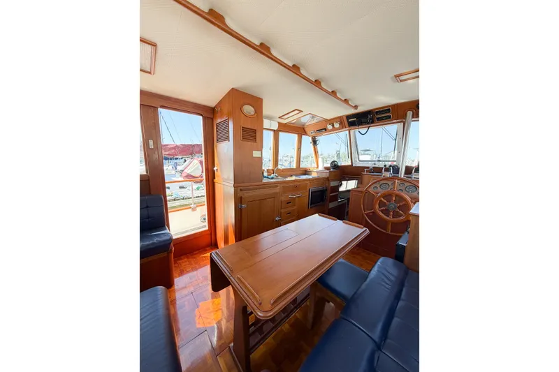 Slide: The Image of Interior of 1991 Grand Banks 36 Classic yacht with wooden furnishings and helm station. - 105