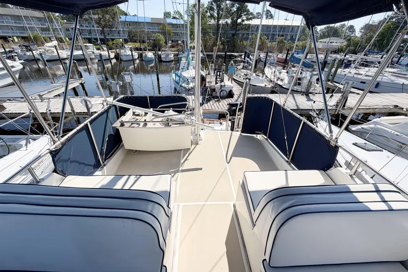 Slide: The Image of Flybridge of 1991 Grand Banks 36 Classic yacht docked at marina with seating and helm. - 12