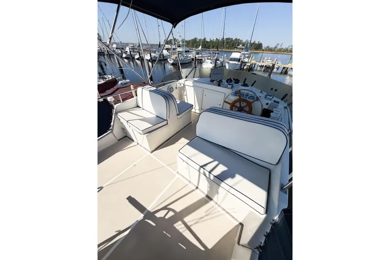 Slide: The Image of Flybridge of 1991 Grand Banks 36 Classic yacht with seating and helm, docked at marina. - 14