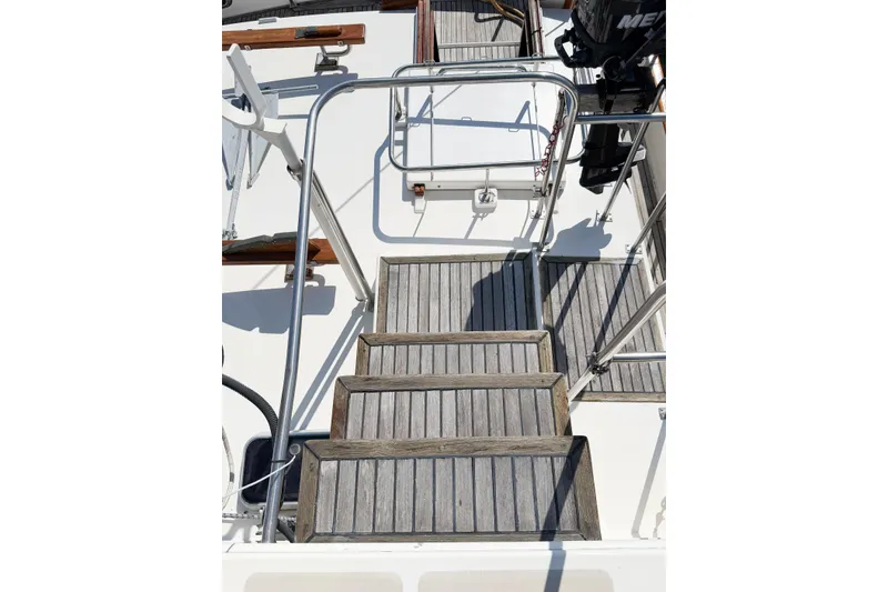 Slide: The Image of Stairs on a 1991 Grand Banks 36 Classic yacht with wooden steps and metal railings. - 15
