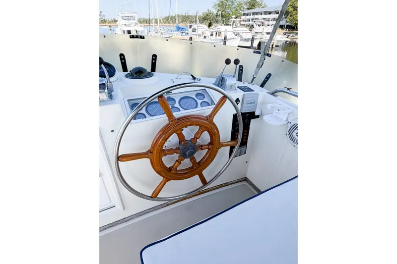 Slide: The Image of Helm of 1991 Grand Banks 36 Classic yacht with wooden steering wheel and navigation instruments. - 17
