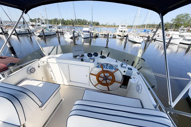 Slide: The Image of Flybridge of 1991 Grand Banks 36 Classic yacht with wooden steering wheel, docked at marina. - 19