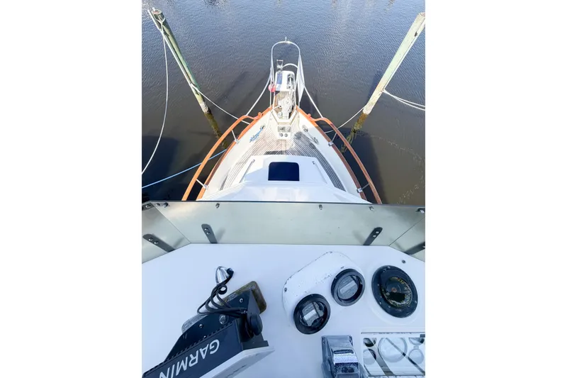 Slide: The Image of 1991 Grand Banks 36 Classic yacht helm view with navigation equipment and water backdrop. - 20