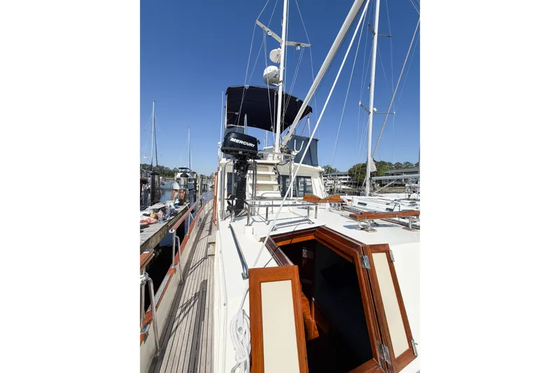 Slide: The Image of 1991 Grand Banks 36 Classic yacht docked, showcasing deck and cabin entrance. - 26