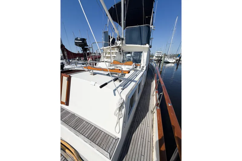 Slide: The Image of 1991 Grand Banks 36 Classic yacht docked at marina, showcasing deck and cabin details. - 28