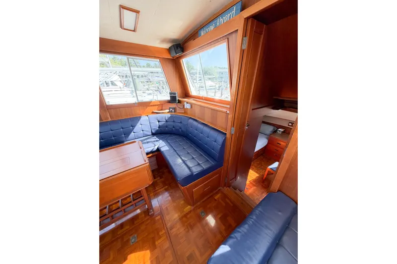 Slide: The Image of Interior of 1991 Grand Banks 36 Classic yacht with blue seating and wooden finishes. - 29