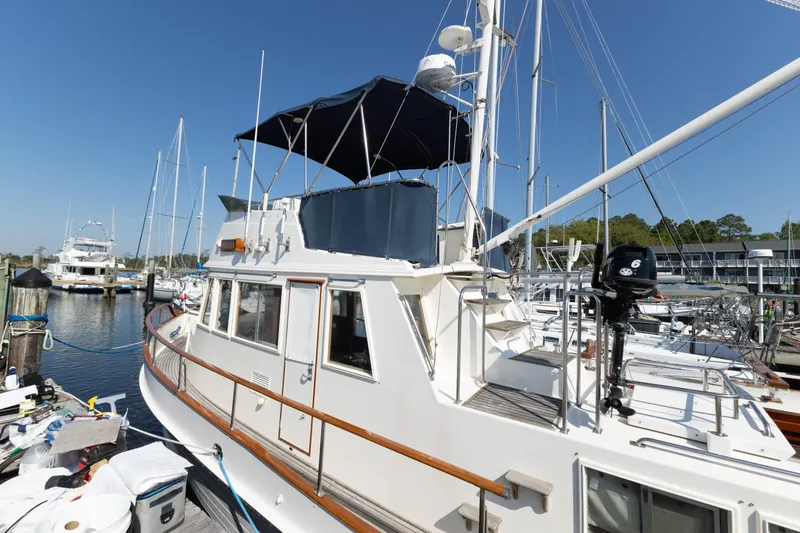 Slide: The Image of 1991 Grand Banks 36 Classic yacht docked at marina under clear blue sky. - 3