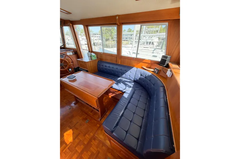 Slide: The Image of Interior of 1991 Grand Banks 36 Classic with blue seating and wooden table. - 30