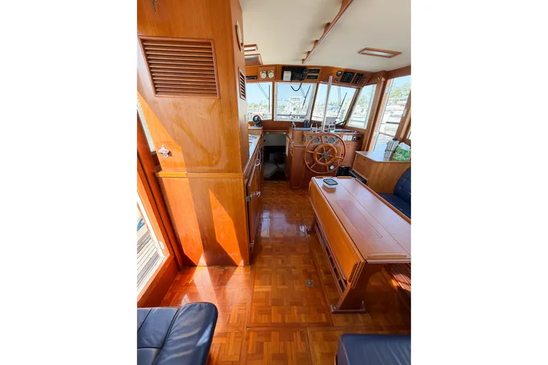 Slide: The Image of Interior of 1991 Grand Banks 36 Classic yacht with wooden furnishings and helm station. - 32
