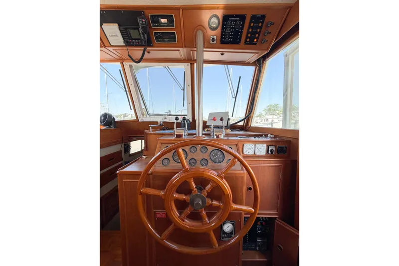 Slide: The Image of 1991 Grand Banks 36 Classic helm with wooden steering wheel and navigation instruments. - 34