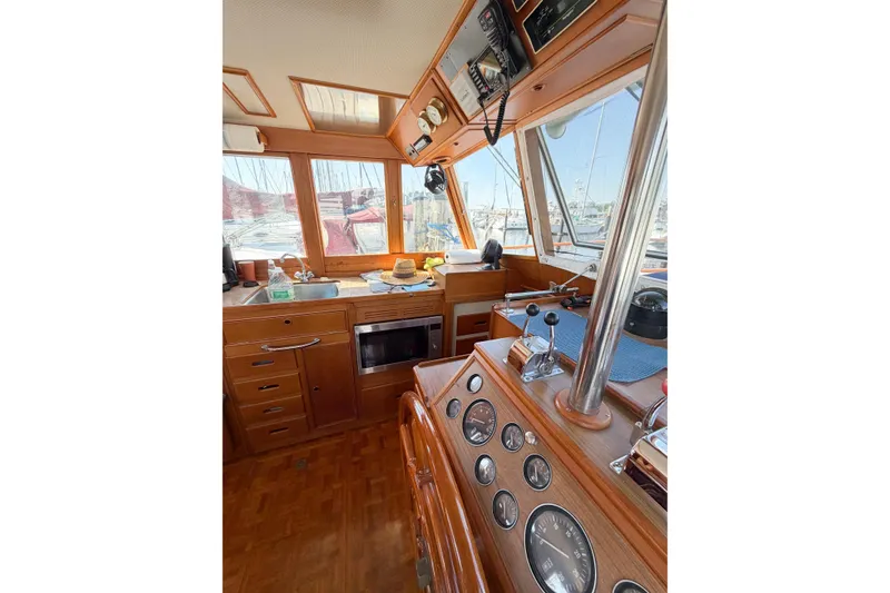 Slide: The Image of Interior of 1991 Grand Banks 36 Classic yacht with wooden helm and navigation instruments. - 35