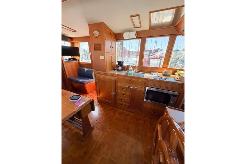 Slide: The Image of Interior of 1991 Grand Banks 36 Classic yacht with wooden cabinetry and seating area. - 36
