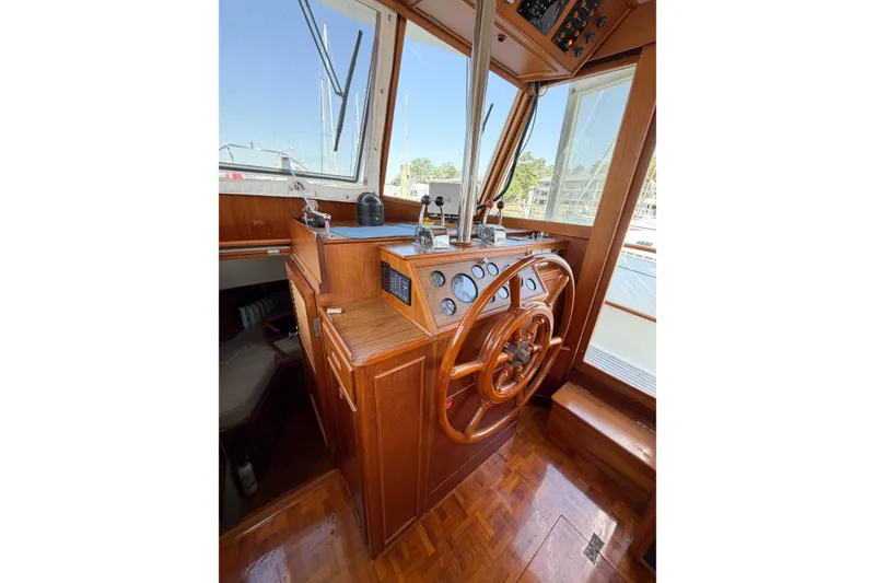 Slide: The Image of Helm of 1991 Grand Banks 36 Classic yacht with wooden steering wheel and navigation instruments. - 39