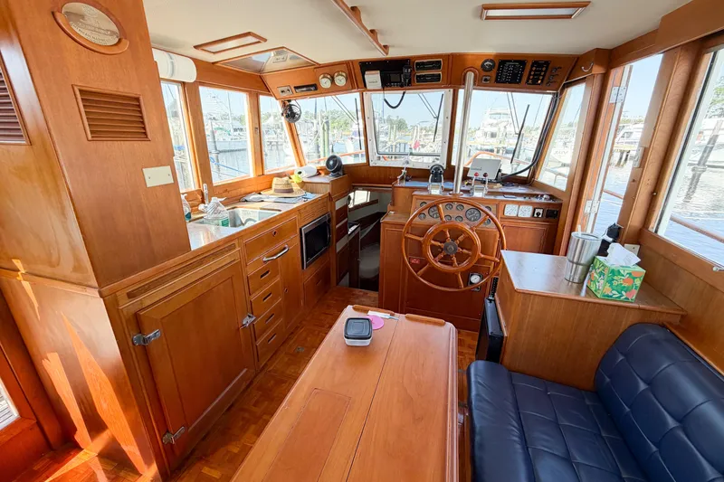 Slide: The Image of Interior of a 1991 Grand Banks 36 Classic yacht with wooden furnishings and helm. - 42