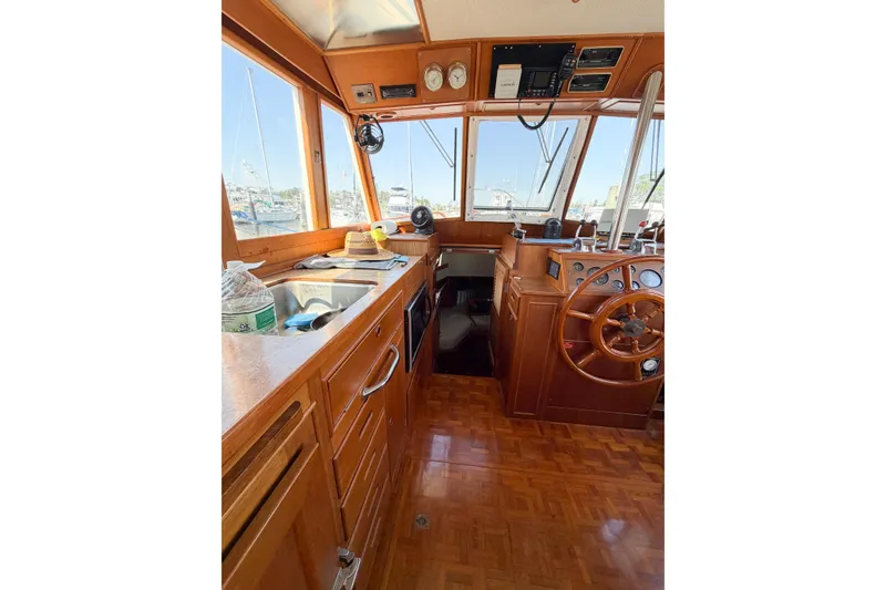 Slide: The Image of Interior of 1991 Grand Banks 36 Classic yacht with wooden helm and galley. - 43