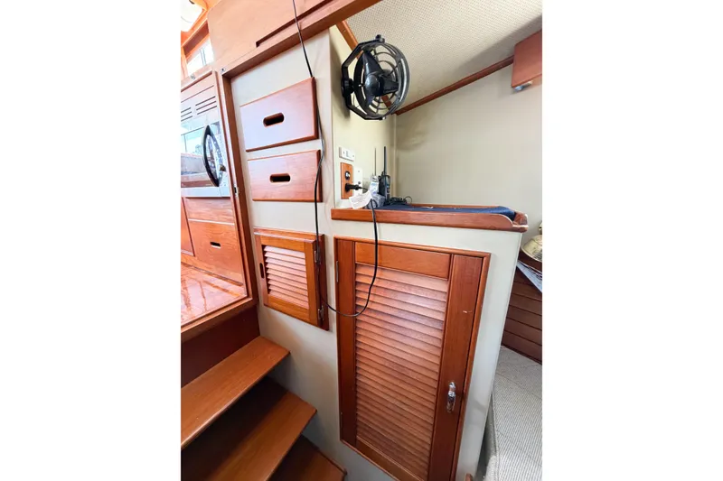 Slide: The Image of Interior of 1991 Grand Banks 36 Classic boat with wooden cabinetry and fan. - 47