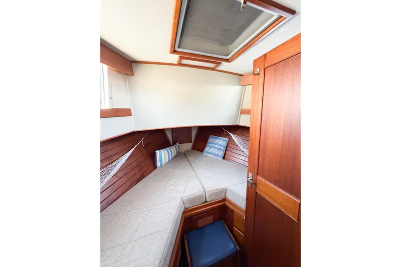 Slide: The Image of Cozy cabin interior of 1991 Grand Banks 36 Classic yacht with wood paneling and cushions. - 48