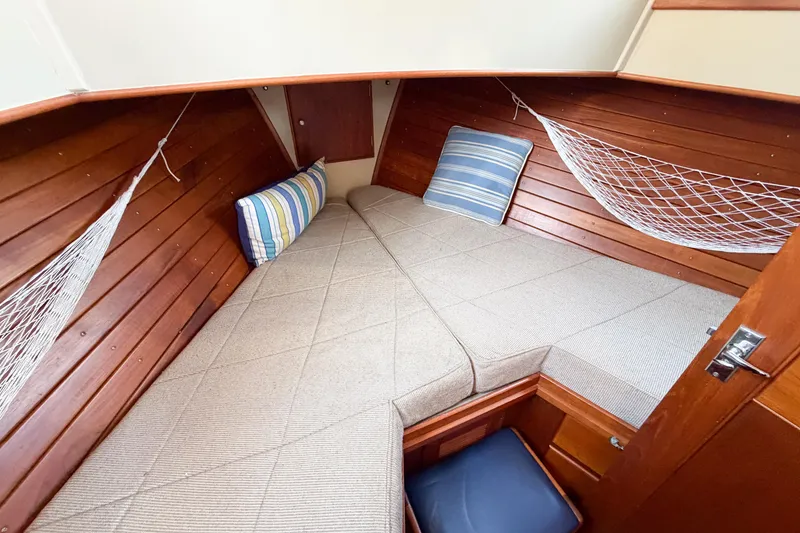 Slide: The Image of Cozy cabin interior of 1991 Grand Banks 36 Classic with wooden paneling and cushions. - 49