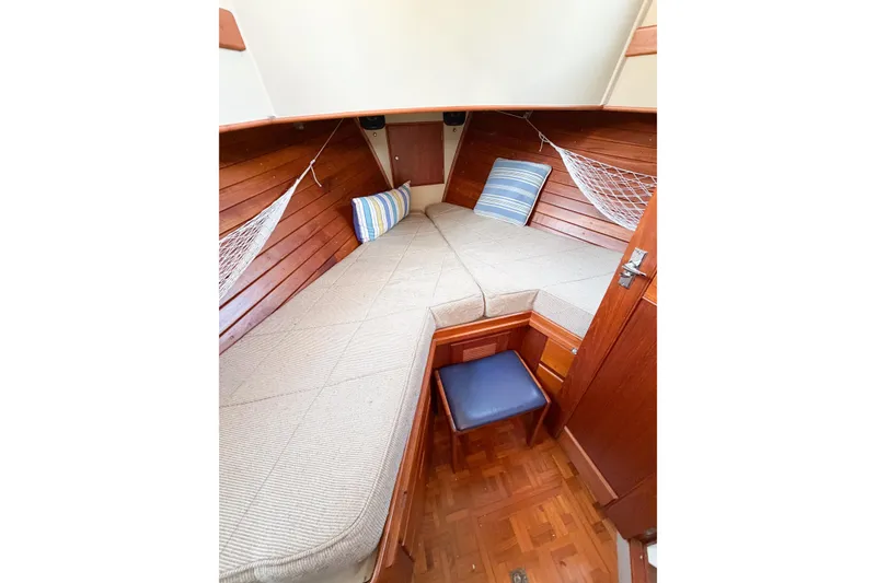 Slide: The Image of Cozy cabin interior of 1991 Grand Banks 36 Classic with wooden finish and striped cushions. - 50