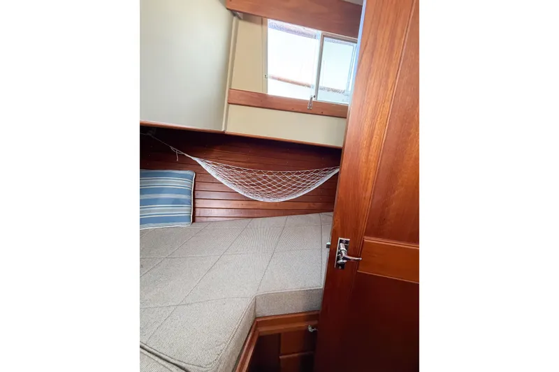 Slide: The Image of Interior cabin of 1991 Grand Banks 36 Classic with wooden finish and cozy bedding. - 51