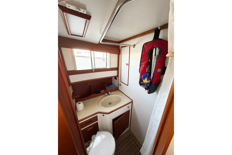 Slide: The Image of Bathroom interior of 1991 Grand Banks 36 Classic yacht with sink and life jacket. - 52