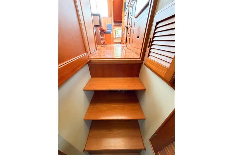 Slide: The Image of Wooden stairs leading to cabin interior of 1991 Grand Banks 36 Classic yacht. - 53