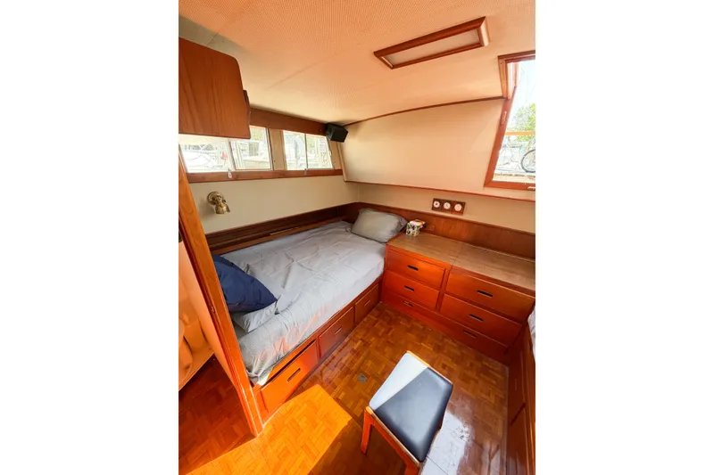 Slide: The Image of Cozy cabin interior of 1991 Grand Banks 36 Classic yacht with wooden furnishings and bed. - 54