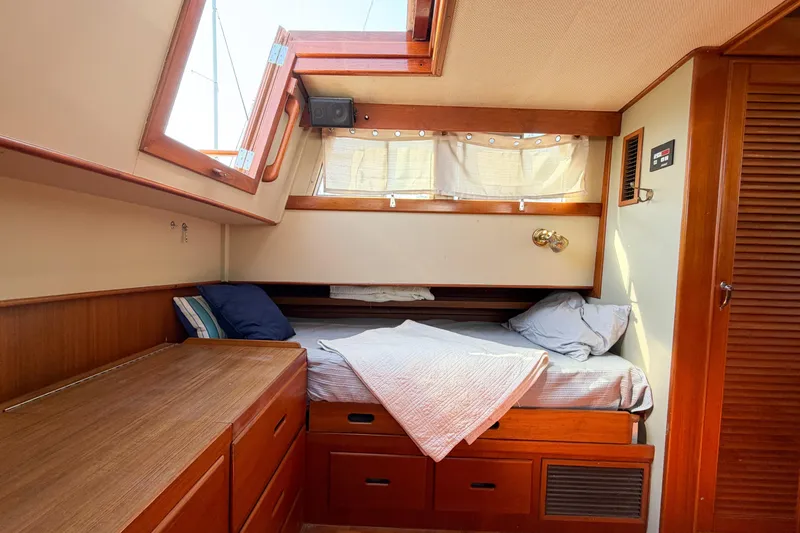 Slide: The Image of Cozy cabin interior of 1991 Grand Banks 36 Classic yacht with wooden furnishings and bedding. - 57