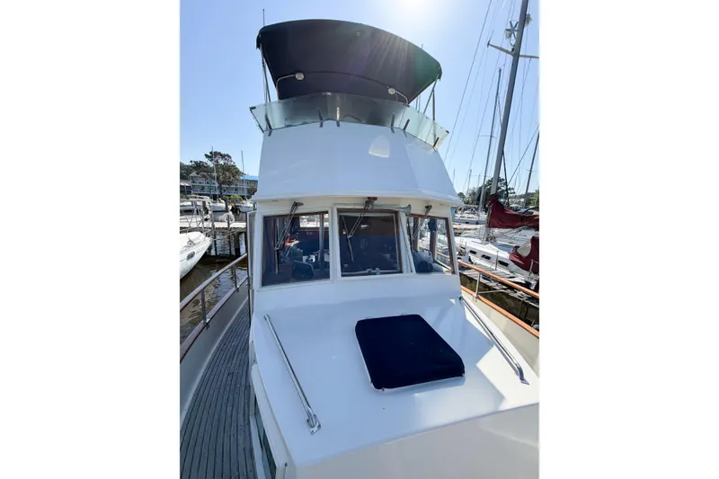 Slide: The Image of 1991 Grand Banks 36 Classic yacht docked at marina, showcasing flybridge and cabin. - 6