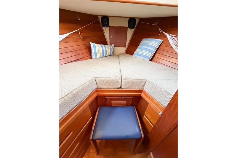Slide: The Image of Cozy cabin interior of 1991 Grand Banks 36 Classic with striped pillows and wooden finish. - 69