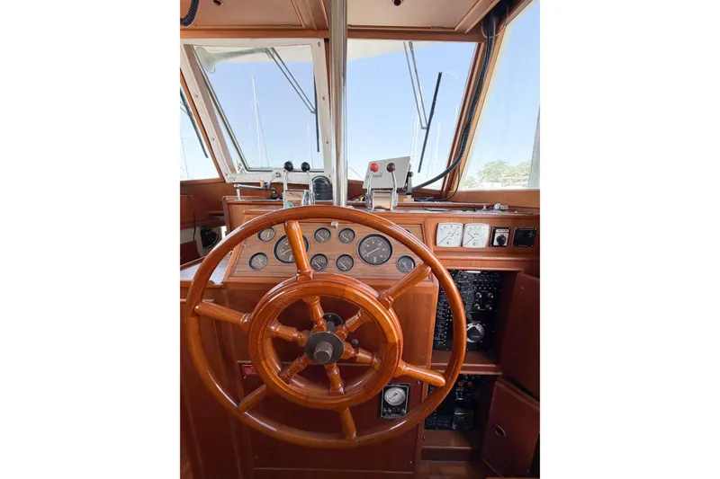 Slide: The Image of Helm of 1991 Grand Banks 36 Classic yacht with wooden steering wheel and instrument panel. - 70