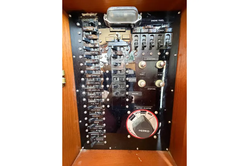 Slide: The Image of Electrical control panel of a 1991 Grand Banks 36 Classic boat, featuring switches and battery selector. - 71