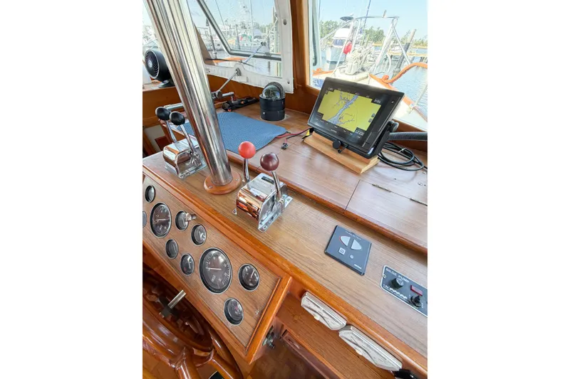 Slide: The Image of Helm of 1991 Grand Banks 36 Classic with navigation equipment and wooden dashboard. - 75