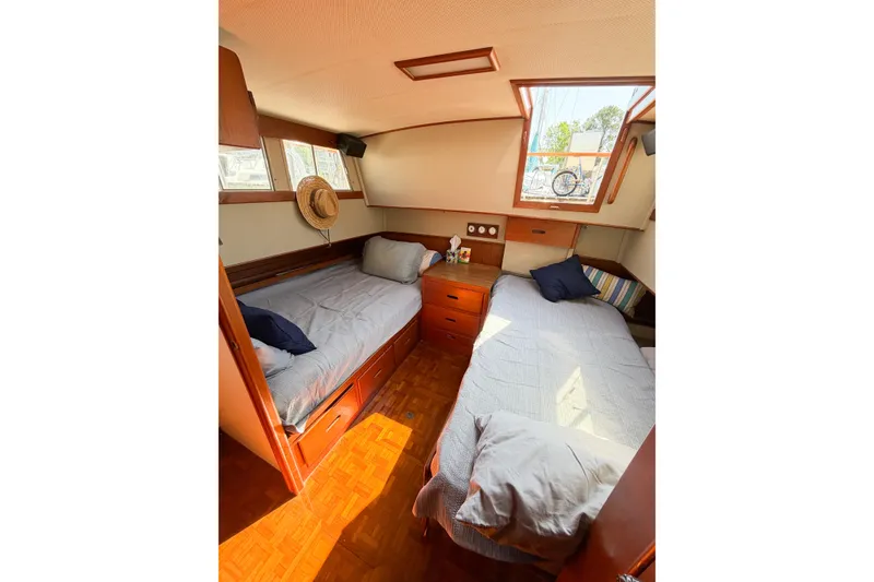 Slide: The Image of Cozy cabin interior of 1991 Grand Banks 36 Classic yacht with twin beds and wooden furnishings. - 78