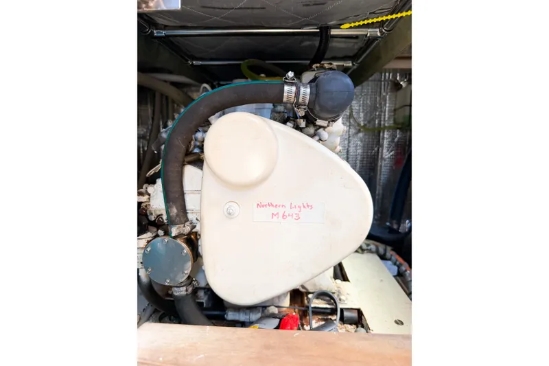 Slide: The Image of Engine compartment of a 1991 Grand Banks 36 Classic boat, featuring Northern Lights generator. - 86