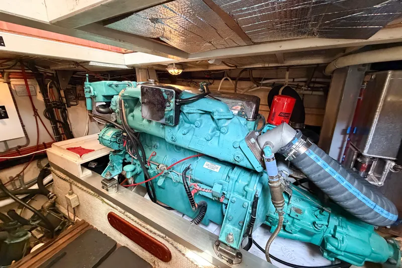 Slide: The Image of Engine room of a 1991 Grand Banks 36 Classic boat, showcasing a teal marine engine. - 87