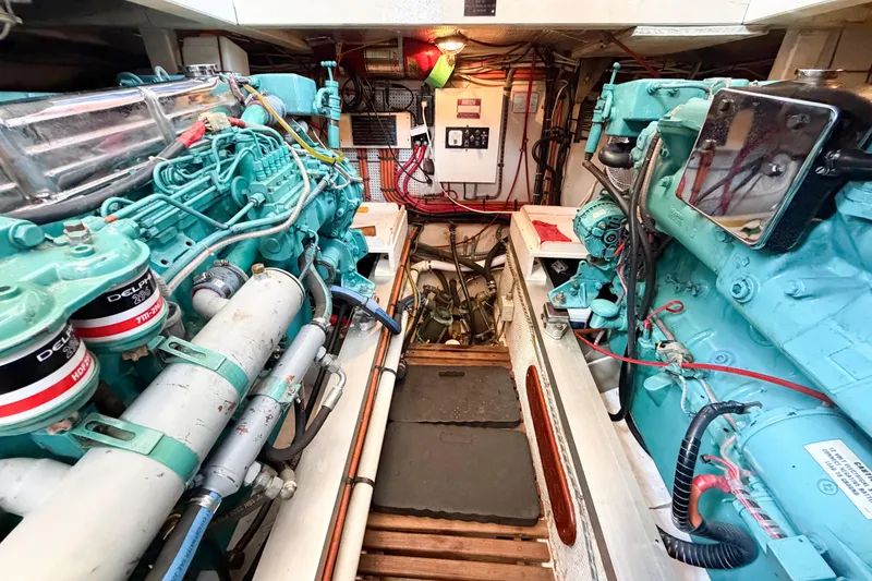 Slide: The Image of Engine room of a 1991 Grand Banks 36 Classic yacht, featuring twin diesel engines. - 89