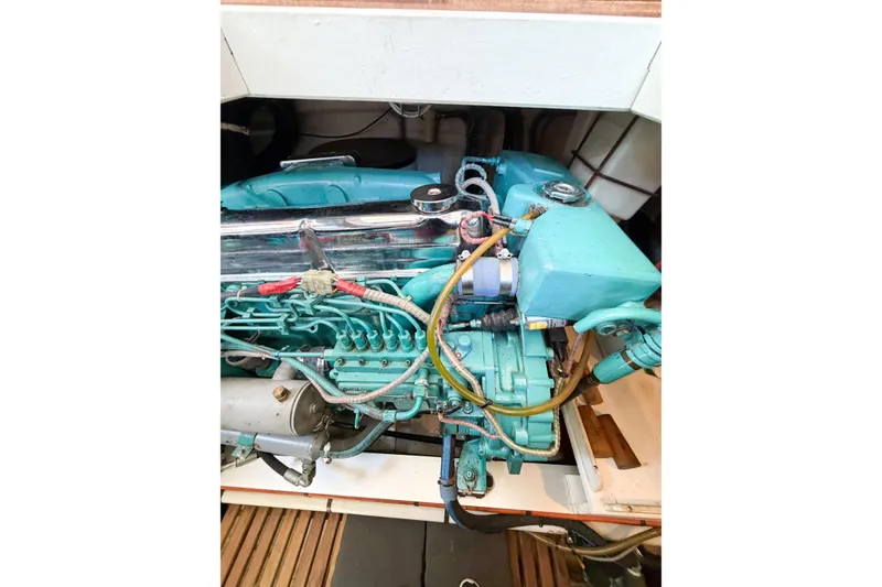 Slide: The Image of Engine compartment of a 1991 Grand Banks 36 Classic boat, showcasing detailed machinery. - 90