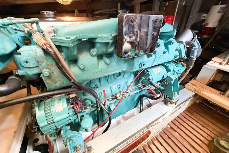 Slide: The Image of Engine room of 1991 Grand Banks 36 Classic, featuring a teal marine engine. - 92