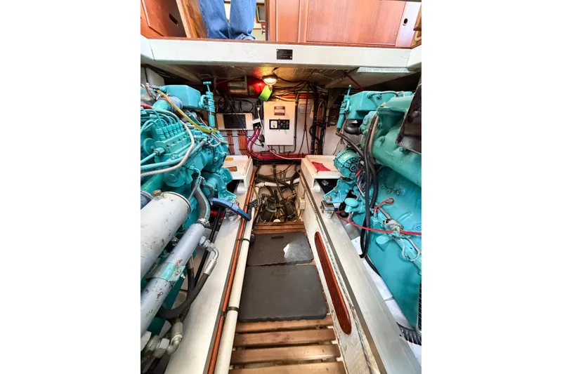 Slide: The Image of Engine room of a 1991 Grand Banks 36 Classic yacht, showcasing dual engines and control systems. - 97