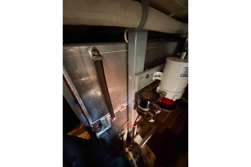 Slide: The Image of Engine room of 1991 Grand Banks 36 Classic, showcasing mechanical components and piping. - 98