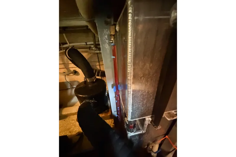 Slide: The Image of Engine room of 1991 Grand Banks 36 Classic boat, showing mechanical components and piping. - 99